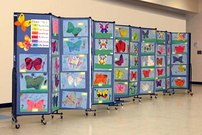 Student artwork displayed on a folding portable partition.